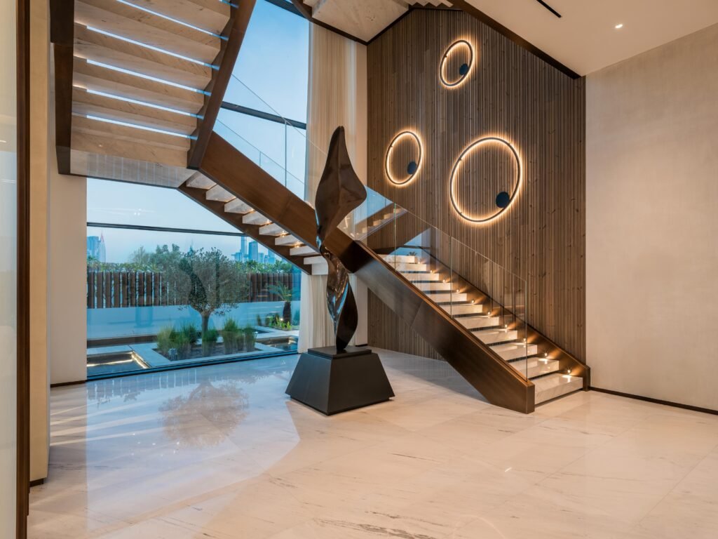 Double height entrance hall with floating marble staircase and bronze sculpture, Harrisoni Villas, La Mer South, Jumeirah 1, Dubai