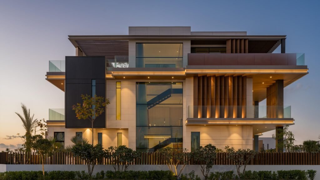 Full front elevation at blue hour with illuminated timber screens, Harrisoni Villas, La Mer South, Jumeirah 1, Dubai