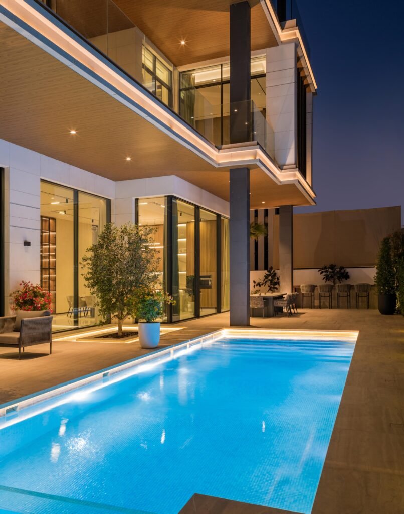 Illuminated lap pool and terrace at night, Harrisoni Villas, La Mer South, Jumeirah 1, Dubai