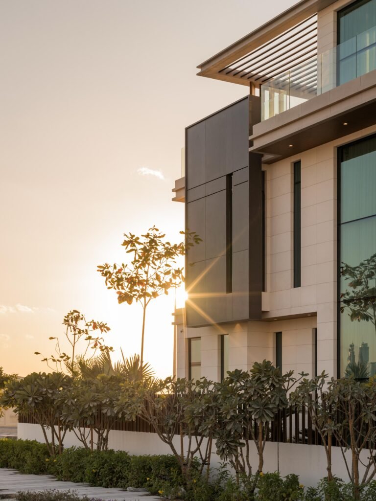 Side elevation at sunset through plumeria planting, Harrisoni Villas, La Mer South, Jumeirah 1, Dubai