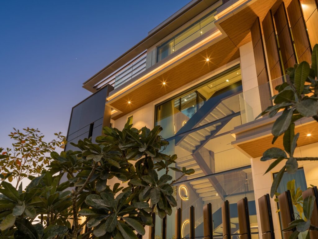 Facade detail at blue hour showing the internal staircase through structural glazing, Harrisoni Villas, La Mer South, Jumeirah 1, Dubai