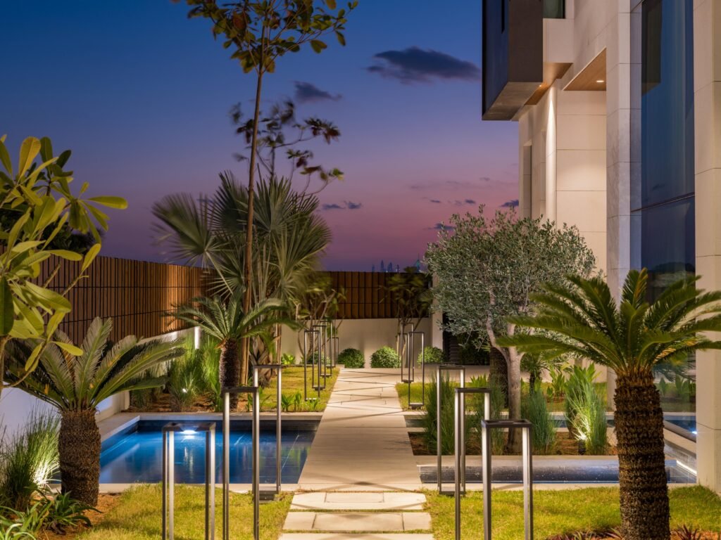 Landscaped garden and lap pool at blue hour, Harrisoni Villas, La Mer South, Jumeirah 1, Dubai