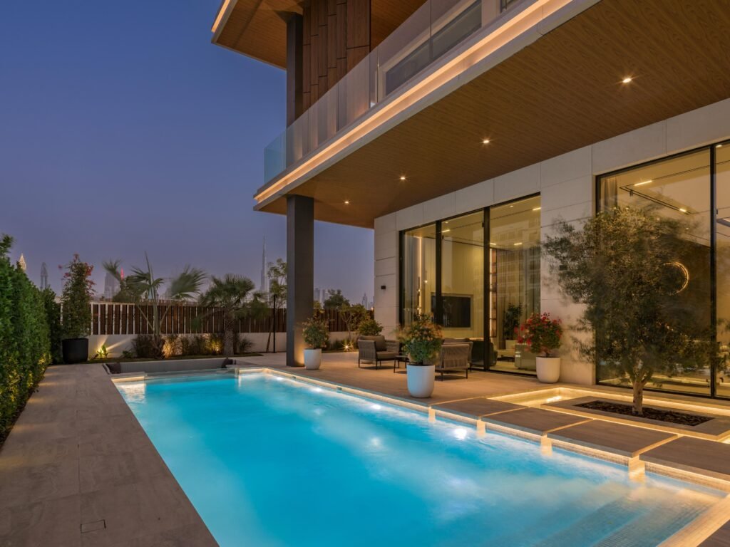 Lap pool and terrace at dusk with the Burj Khalifa on the horizon, Harrisoni Villas, La Mer South, Jumeirah 1, Dubai