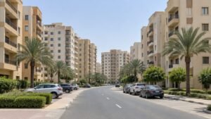 Beige mid rise apartment buildings on a quiet residential street in an inland Dubai community