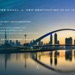 The Dubai Water Canal and Tolerance Bridge at sunset with the Dubai skyline